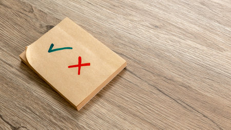 Sticky Note with Check Mark and Cross on Wooden Surface