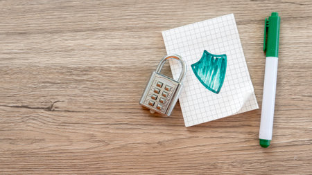 Combination Lock, Shield Drawing, and Green Pen on Graph Paper Notebookの写真素材