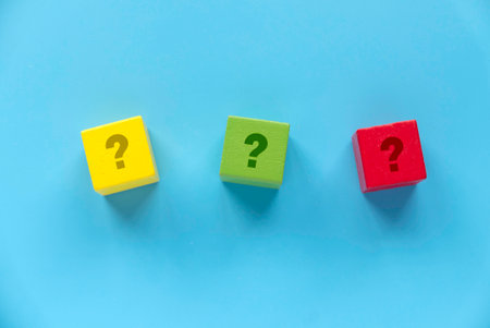 Colorful Wooden Blocks with Question Marks on Blue Background