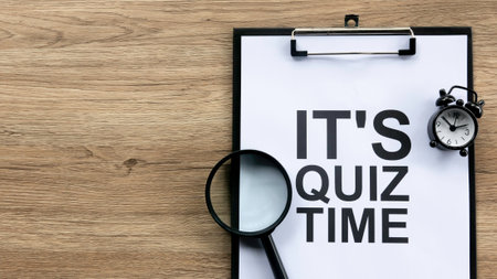 Urgent Quiz Preparation Concept with Clipboard, Alarm Clock, and Magnifying Glass