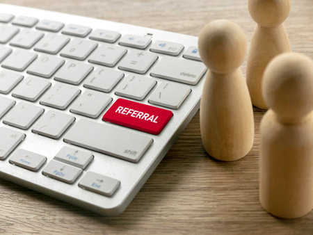 Referral Button Keyboard with Wooden People Figuresの写真素材