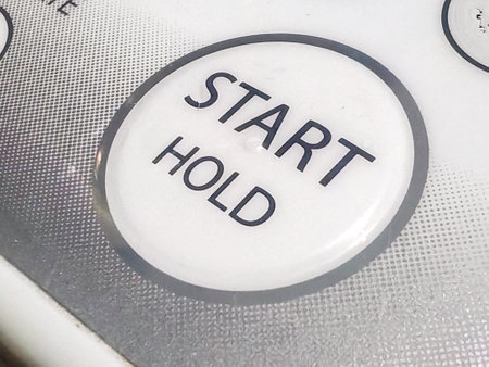 Close-up View of a START HOLD Button on a Control Panel.