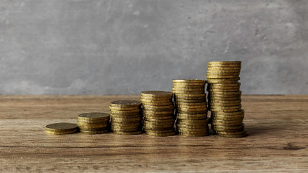 stacked coins on wooden surfaceの写真素材