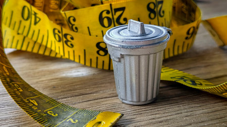 Miniature Garbage Bin on a Tape Measureの写真素材