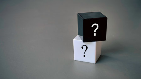 Question and answer concept. Stack of black and white cube with a symbol of question mark.