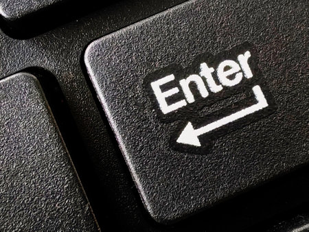 Close up of enter button on computer keyboard.
