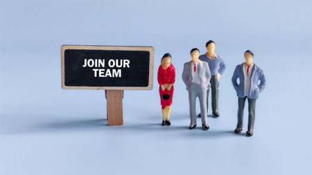 Group of Professional Workers Standing Together Beside a Sign That Reads 'Join Our Team' Representing Recruitment, Teamwork, and Career Opportunityの写真素材