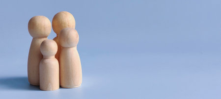 Family Members Including Father, Mother, Daughter, and Son on Blue Background Representing Unity, Love, and Togethernessの写真素材