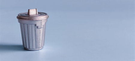 Trash Can Isolated on Blue Background with Copy Space Representing Waste Management, Cleanliness,...