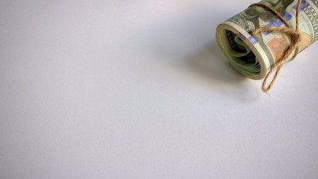 Rolled Bundle of US Dollar Bills Tied with Twine: Financial Symbolism and Economic Significance