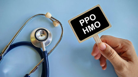 a hand holding notification board written with 'PPO HMO' with stethoscope beside it.