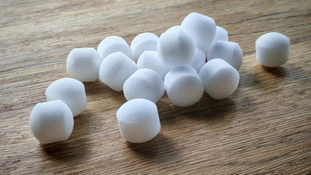 White naphthalene balls on blue background.
