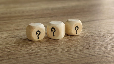 Three Wooden Dice with Question Marksの写真素材