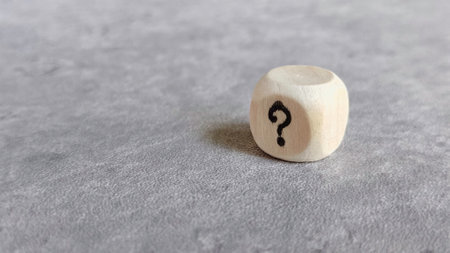 A Wooden Dice with Question Marksの写真素材