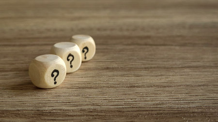 Three Wooden Dice with Question Marksの写真素材