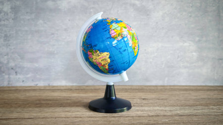 Detailed World Globe on Wooden Table, Symbolizing Global Business, Travel, and International Conceptsの写真素材