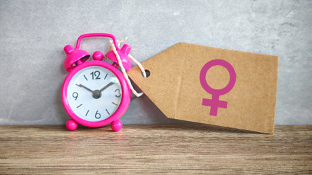 Pink Alarm Clock and Female Symbol Tag: A Conceptual View of Menopause and the Biological Clockの写真素材