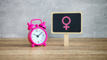 Pink Alarm Clock and Female Symbol Tag: A Conceptual View of Menopause and the Biological Clockの写真素材