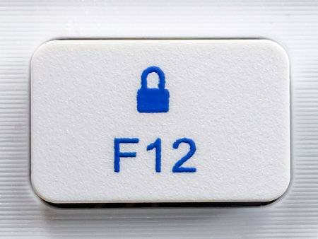 Close-up of a White F12 Lock Function Key on a Modern Keyboard.