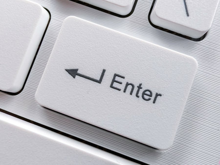 Close-up of a White Enter Key on a Modern white Keyboard.