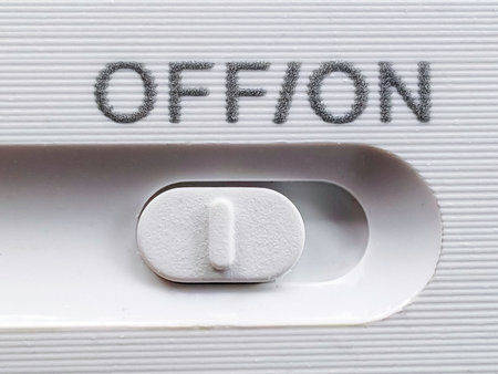 Close-up of a White "Off/On" Slider Switch on a Modern Electronic Device.の写真素材