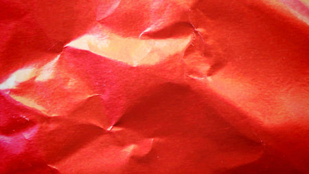 Crimson red metallic foil background, a crumpled and wrinkled paper textureの写真素材
