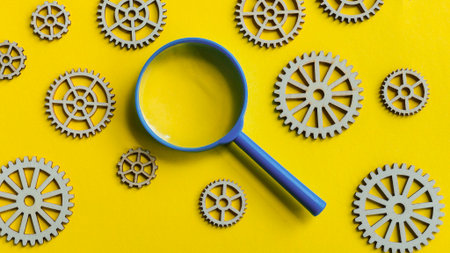 Magnifying glass inspecting a mechanism of gears for research, analysis, and problem-solving on a...