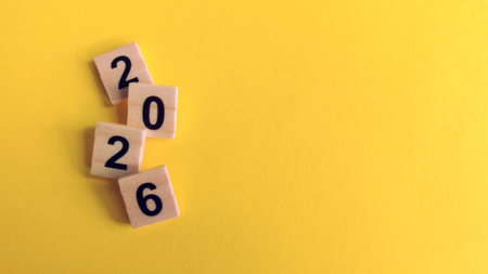 2026 wooden numbers on a vibrant yellow background, symbolizing the New Year, future timeline,...