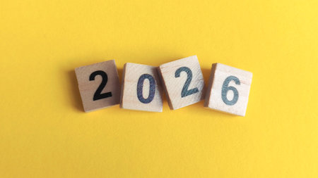 2026 wooden numbers on a vibrant yellow background, symbolizing the New Year, future timeline, annual planning, and bright opportunities.の写真素材