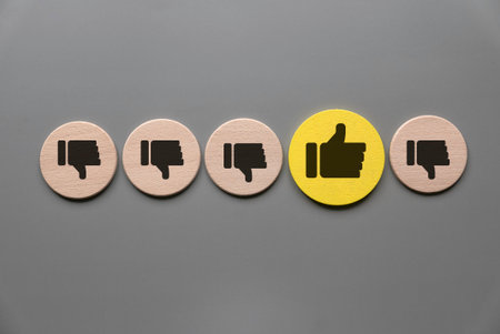Positive Feedback Standing Out: Contrasting Like Symbol Among Dislike Icons on Neutral Background Representing Unique Opinion or Excellent Ratingの写真素材