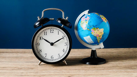 Vintage Alarm Clock and Small World Globe Symbolizing Global Time and Deadlines