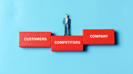 Market Positioning and Competitive Strategy concept with a miniature figure standing on wooden blocks labeled CUSTOMERS, COMPETITORS, and COMPANY, illustrating business advantage.の写真素材