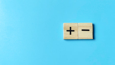 Pros and Cons or Risk versus Reward concept illustrated by plus and minus signs on wooden blocks, symbolizing decision-making and evaluation.の写真素材