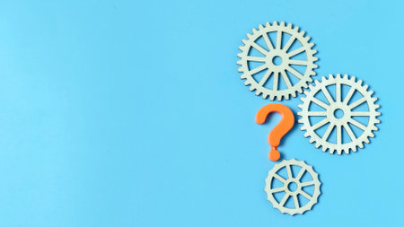 Question Mark and Wooden Gears, representing a systemic problem or a strategic question about process and solution in business.の写真素材