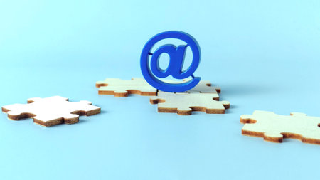 Blue At Symbol on Wooden Jigsaw Puzzle Pieces Representing Email Integration, Communication Solutions, and Connecting Onlineの写真素材