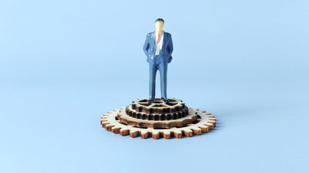 Corporate Management and System Leadership Concept: Miniature Businessman Standing on Wooden Gearsの写真素材