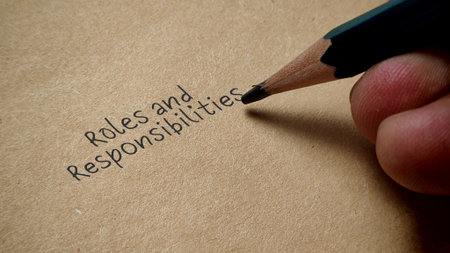 Hand Writing Roles and Responsibilities with Pencil on Brown Paper Job Description Business Conceptの写真素材