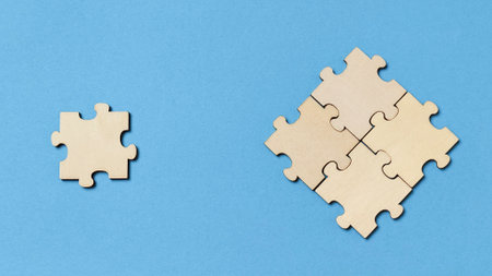 Missing Piece Concept: Wooden Jigsaw Puzzle Pieces on Blue Background