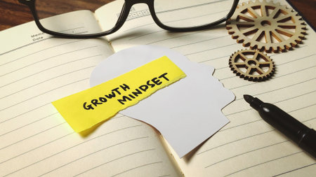 Developing a Growth Mindset: Mental Concept on Paper Head Silhouette with Gearsの写真素材