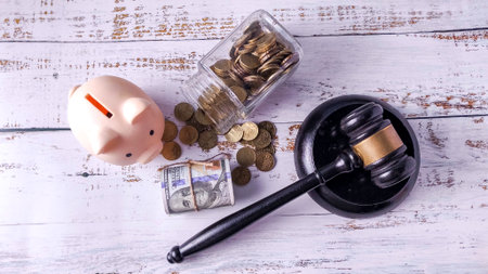 Gavel, Piggy Bank, Coins, and Money on Wood: Financial Law, Legal Savings, Fraud, and White-Collar Crimeの写真素材