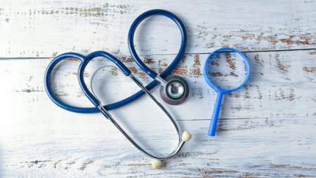 Stethoscope and Magnifying Glass on a Wooden Table: Healthcare Research, Medical Investigation, and Diagnostic Toolsの写真素材