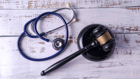 Stethoscope and Gavel on a Wooden Table: Medical Malpractice, Healthcare Law, and Ethical Regulationの写真素材