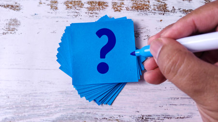 Hand Writing Question Mark: Stack of Blue Sticky Notes with Marker Penの写真素材