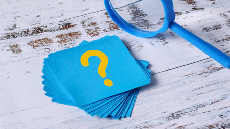 Question Mark Search: Stack of Blue Sticky Notes and Magnifying Glass on Woodの写真素材