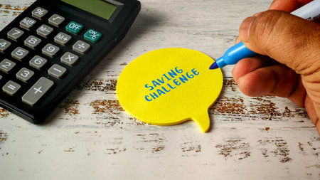 Saving Challenge Financial Plan Concept with Calculator and Hand Writing on Speech Bubble Note Padの写真素材