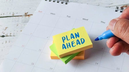 Plan Ahead Future Strategy Concept with Hand Writing on Sticky Notes Placed on Calendarの写真素材