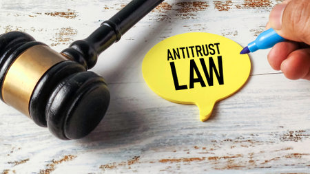 Gavel Next to a Speech Bubble with "Antitrust Law" Written on It, Representing Legal Regulation, Competition, and Corporate Monopolyの写真素材