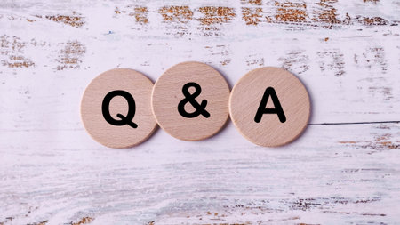 Three Circular Wooden Discs Lined Up with "Q & A" Written on Them, Representing Questions, Answers, and FAQ Sectionの写真素材
