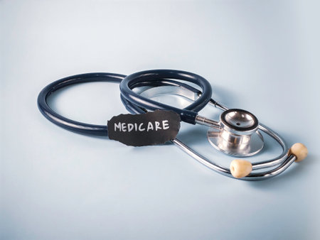 Stethoscope Near Piece of Paper with "Medicare" Text on Blue Background: A Concept for US Government Health Insurance and Senior Healthcareの写真素材