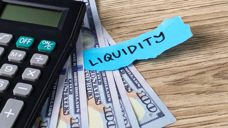 Liquidity Calculation Concept with Calculator, US Dollars, and Note Representing Business Finance and Cash Flowの写真素材